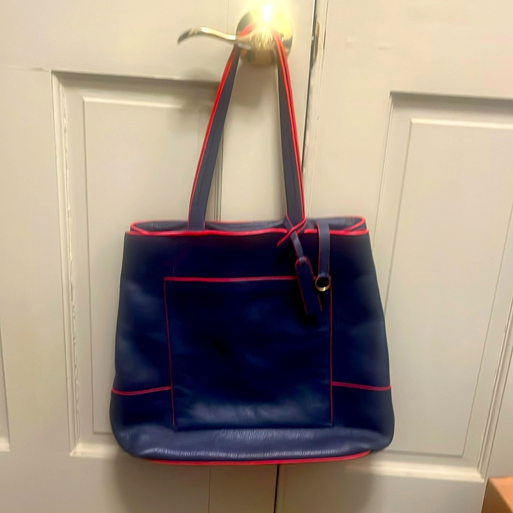 Leather tote. 13x13, straps 22”. Three snap closures. Three inside pockets.